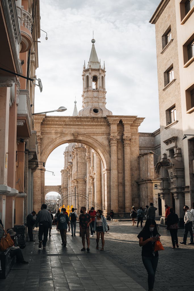 People Walking on Street with Tower of Basilica Cathedral of Arequipa behind
